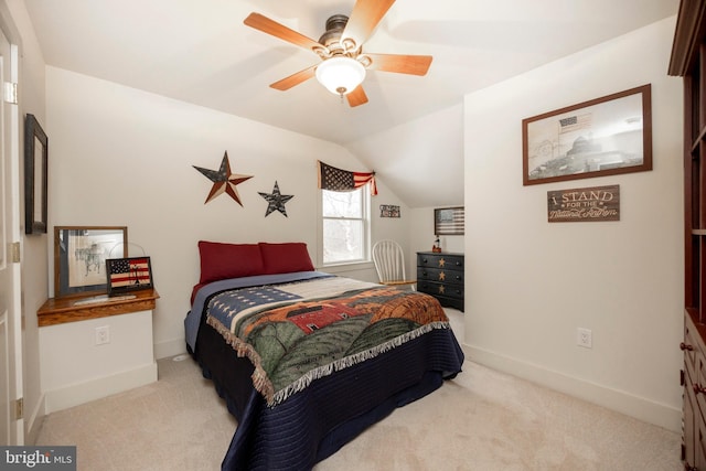 carpeted bedroom featuring ceiling fan and vaulted ceiling