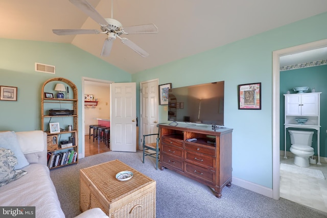 living room featuring light carpet, visible vents, baseboards, lofted ceiling, and ceiling fan