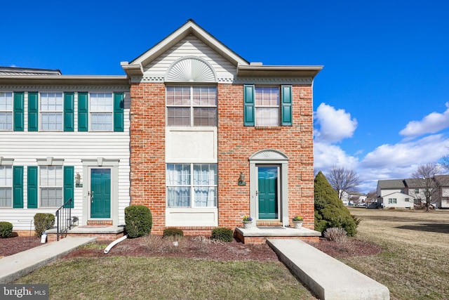 view of property featuring brick siding