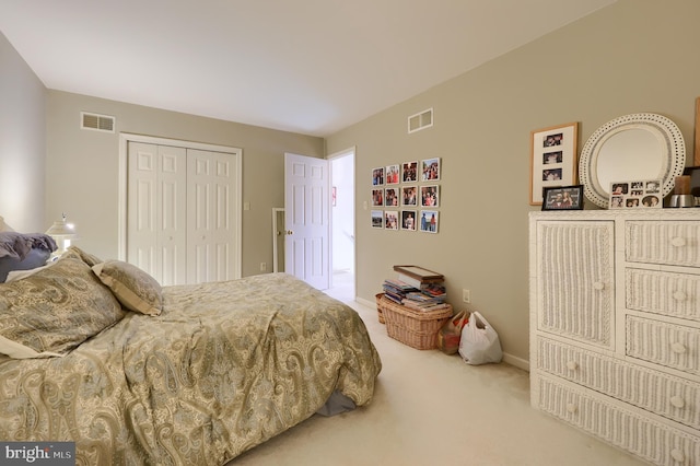 carpeted bedroom with a closet and visible vents