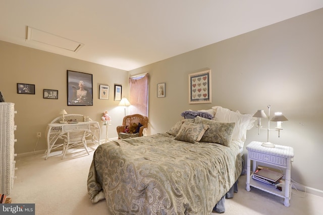 bedroom with baseboards, attic access, and light colored carpet