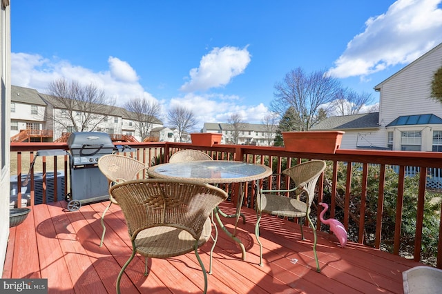 deck with a residential view, area for grilling, and outdoor dining space