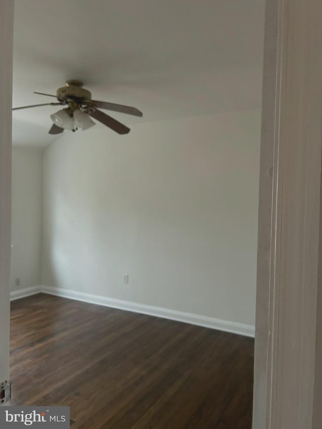 empty room featuring ceiling fan and dark hardwood / wood-style flooring