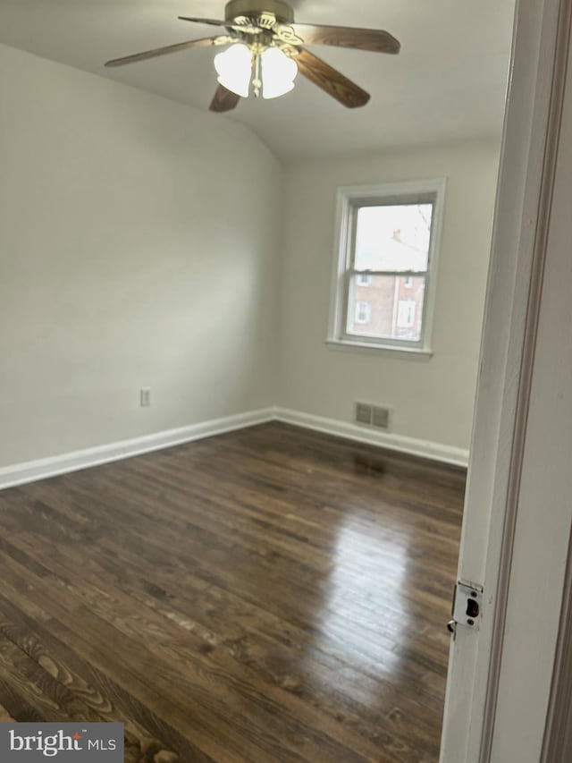 spare room with ceiling fan and dark hardwood / wood-style floors