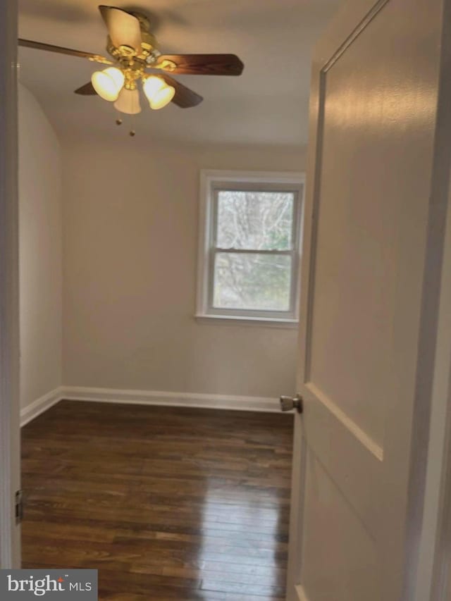 unfurnished room with ceiling fan and dark hardwood / wood-style flooring