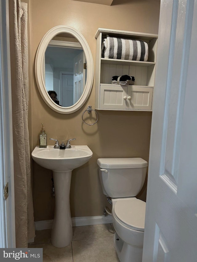 bathroom featuring tile patterned floors and toilet