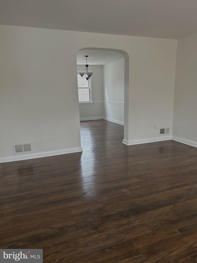 unfurnished room with dark hardwood / wood-style floors