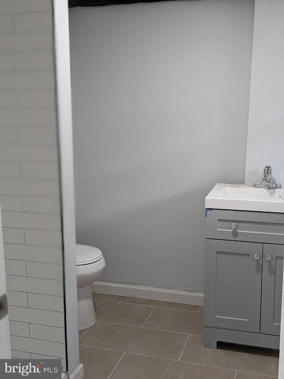 bathroom featuring toilet and vanity