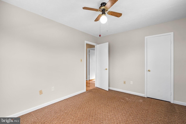 unfurnished bedroom with ceiling fan and carpet