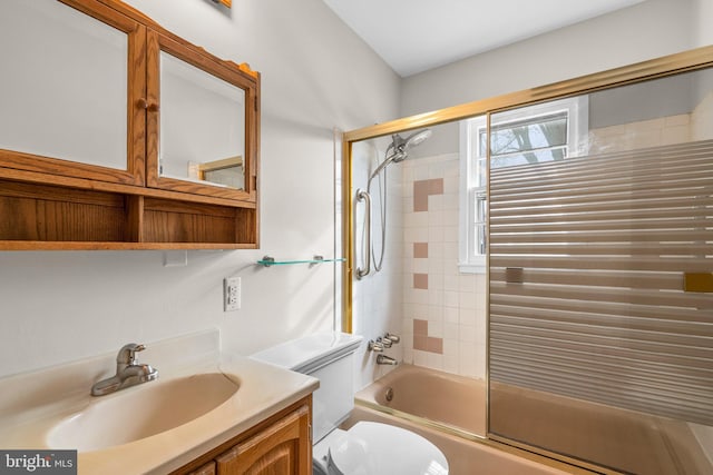 full bathroom featuring vanity, enclosed tub / shower combo, and toilet