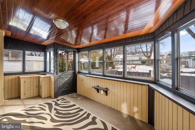 sunroom / solarium with lofted ceiling and wooden ceiling