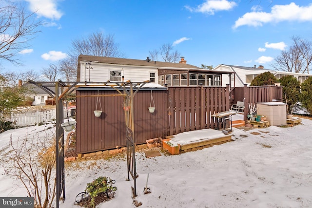 snow covered property featuring a wooden deck