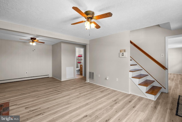 unfurnished living room featuring ceiling fan, light hardwood / wood-style flooring, a textured ceiling, and baseboard heating