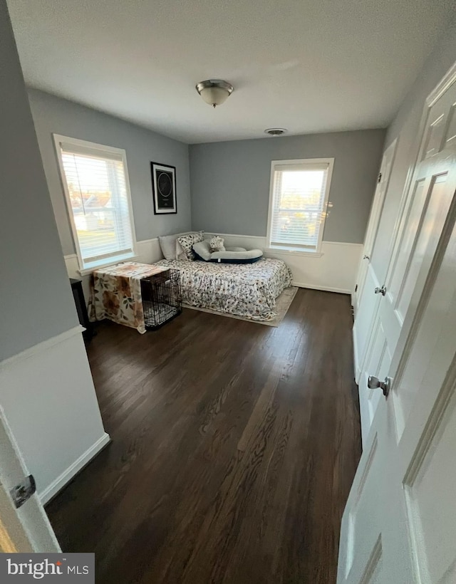 bedroom with dark hardwood / wood-style floors