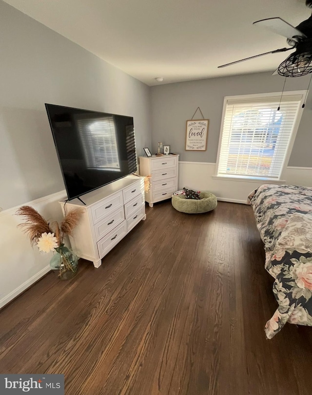 bedroom with dark hardwood / wood-style floors and ceiling fan