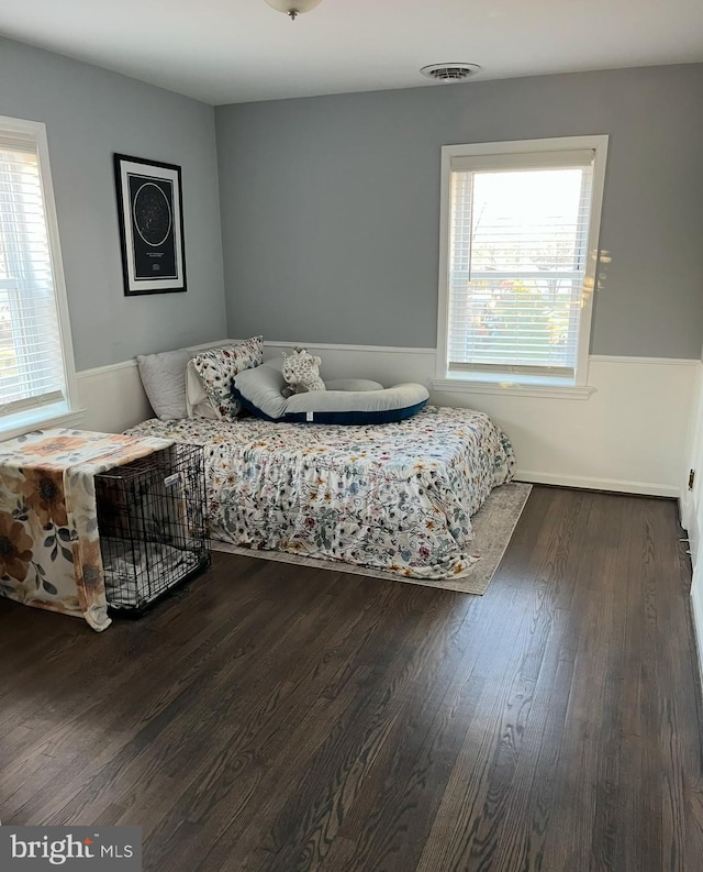 bedroom with dark hardwood / wood-style flooring