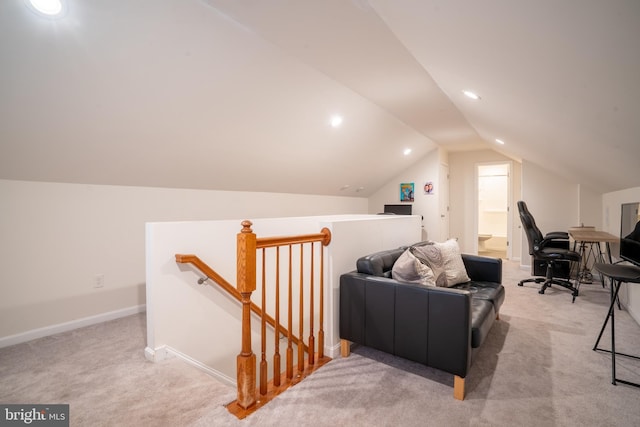 interior space with lofted ceiling and light colored carpet