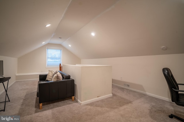 carpeted home office with lofted ceiling