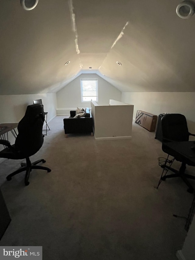 carpeted office space featuring vaulted ceiling