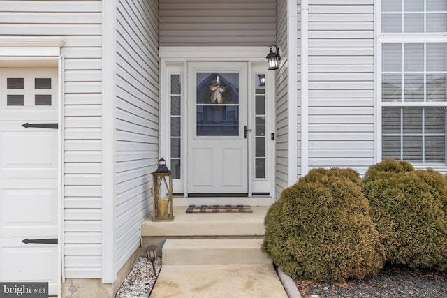 view of exterior entry with a garage