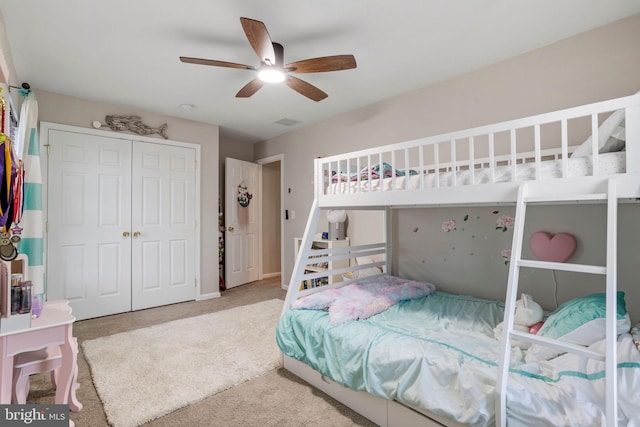 bedroom with ceiling fan, a closet, and carpet flooring