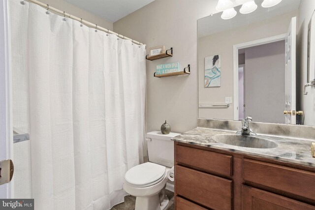 bathroom featuring toilet and vanity