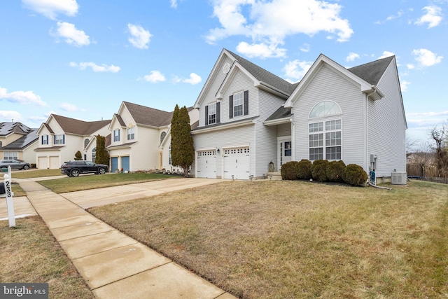 front facade with a front yard, a garage, and cooling unit