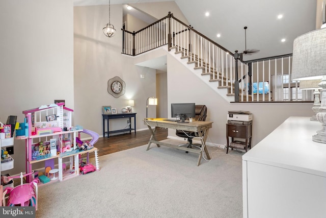 interior space with ceiling fan and carpet flooring