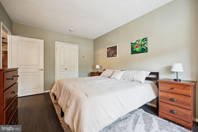 bedroom with a closet and dark hardwood / wood-style flooring