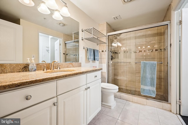 bathroom with toilet, tile patterned flooring, walk in shower, and vanity