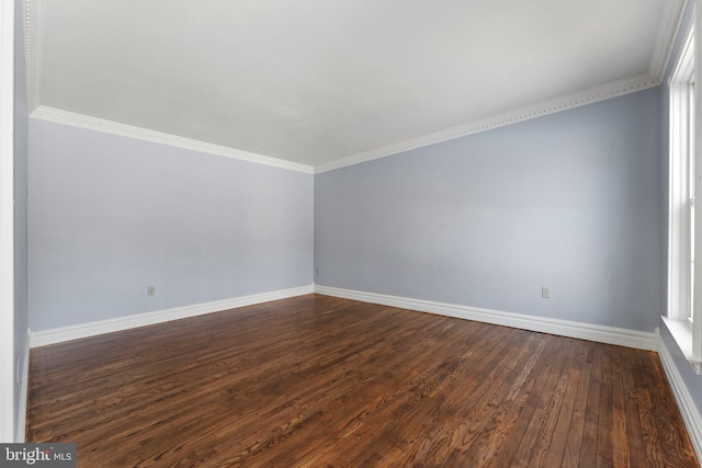 unfurnished room with crown molding and dark wood-type flooring