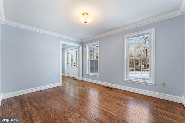 spare room with hardwood / wood-style flooring and crown molding