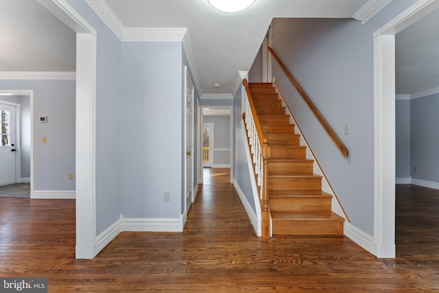 staircase with crown molding and hardwood / wood-style floors