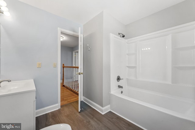 bathroom with hardwood / wood-style flooring, vanity, and bathtub / shower combination