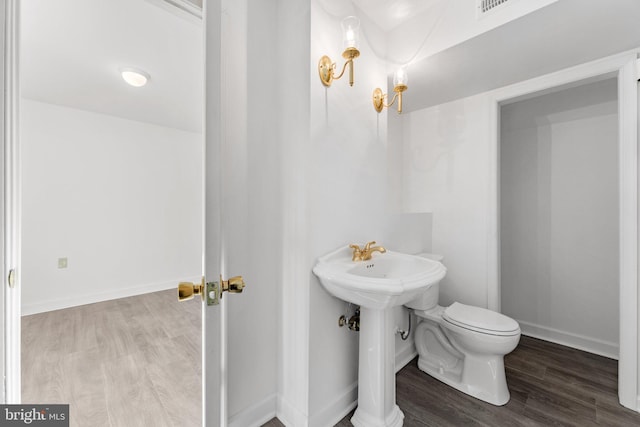 bathroom featuring hardwood / wood-style floors and toilet