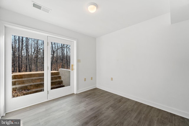 empty room with hardwood / wood-style floors