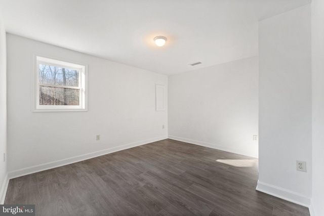 unfurnished room with dark hardwood / wood-style flooring