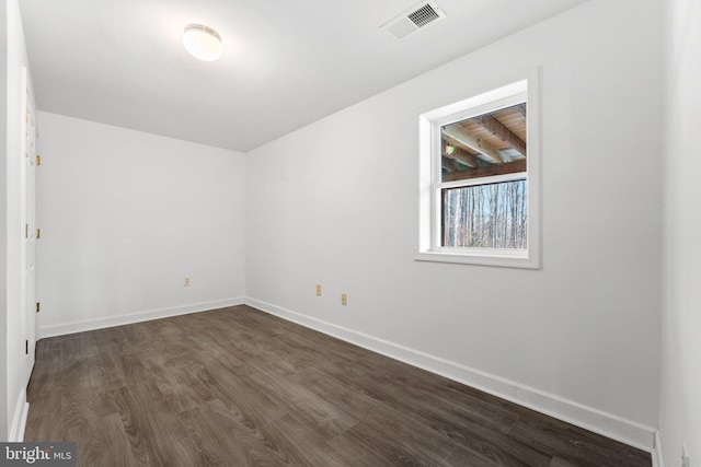 unfurnished room with dark hardwood / wood-style floors