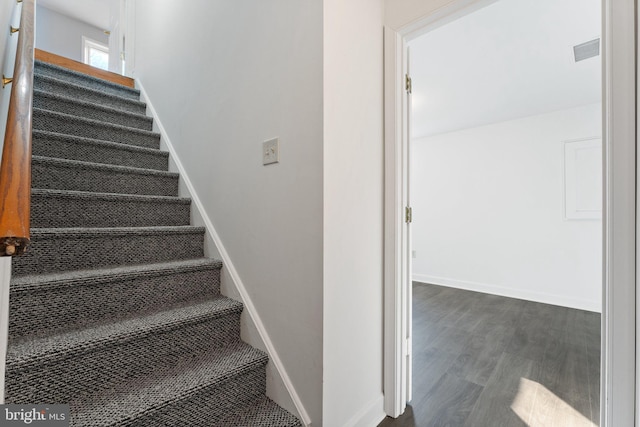 staircase featuring hardwood / wood-style floors