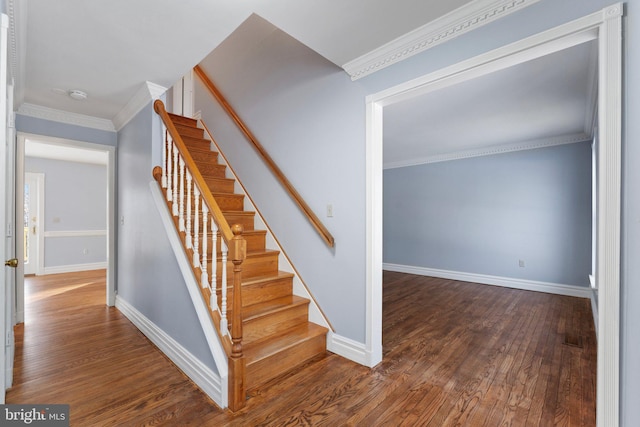 stairway with hardwood / wood-style floors and crown molding