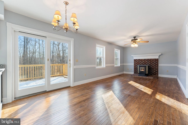 unfurnished living room featuring dark hardwood / wood-style flooring and ceiling fan with notable chandelier