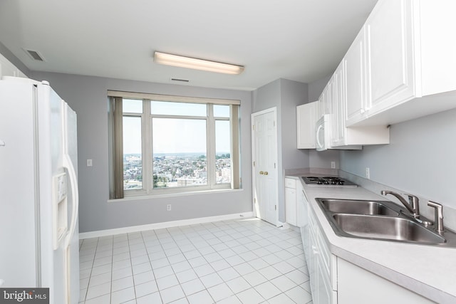 kitchen with white cabinets, sink, white appliances, and light tile patterned flooring