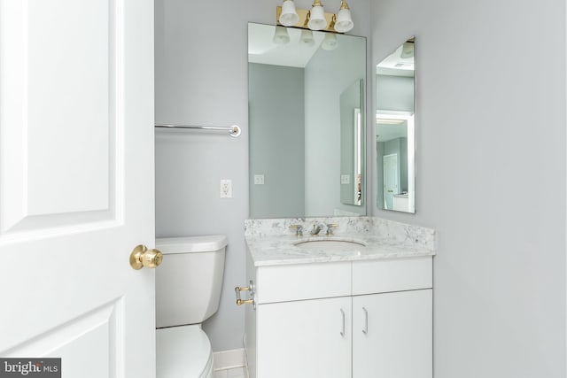 bathroom featuring toilet and vanity