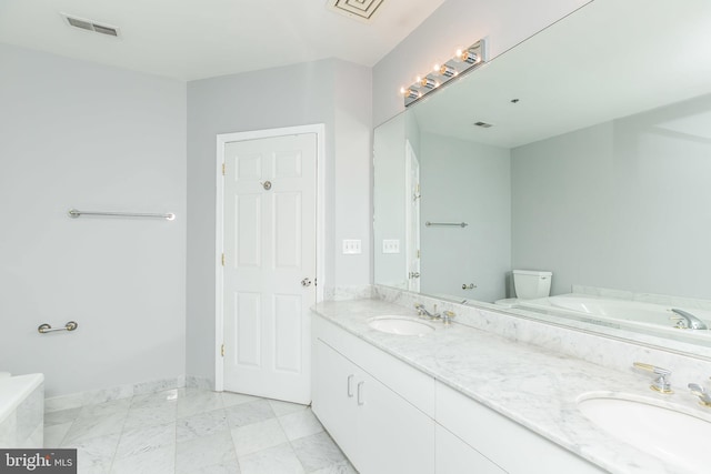 bathroom featuring toilet and vanity