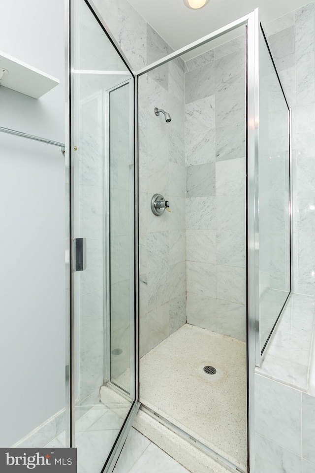 bathroom featuring an enclosed shower and tile patterned flooring