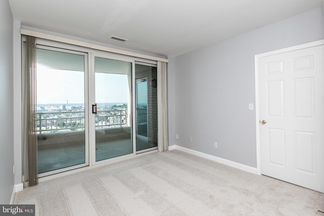 unfurnished room with light colored carpet