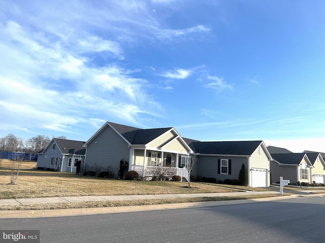 ranch-style house with a garage, a porch, and a front lawn