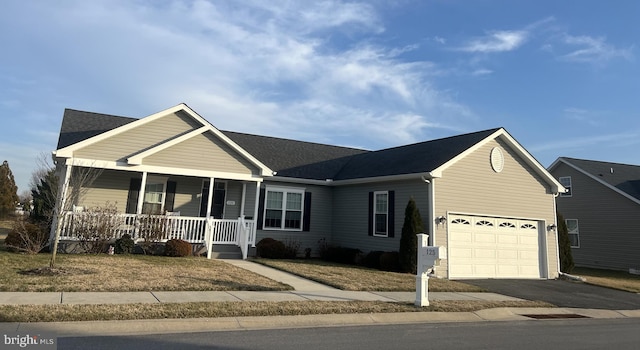 ranch-style house featuring a garage and covered porch