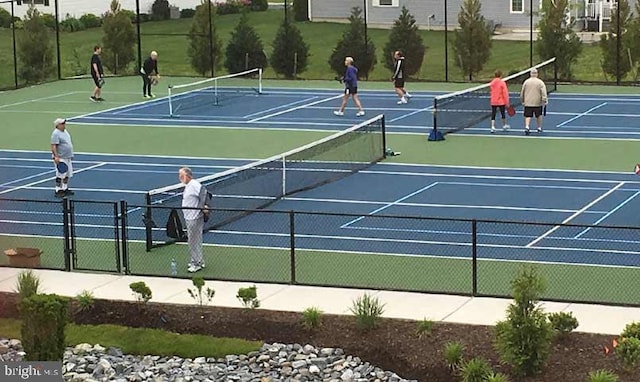 view of tennis court with basketball hoop