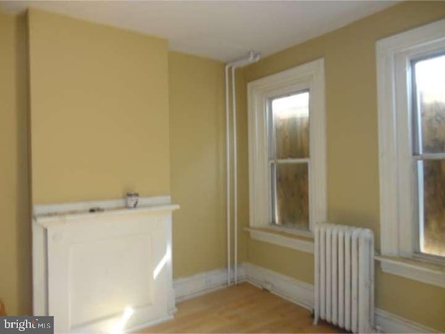 interior space featuring hardwood / wood-style flooring and radiator heating unit